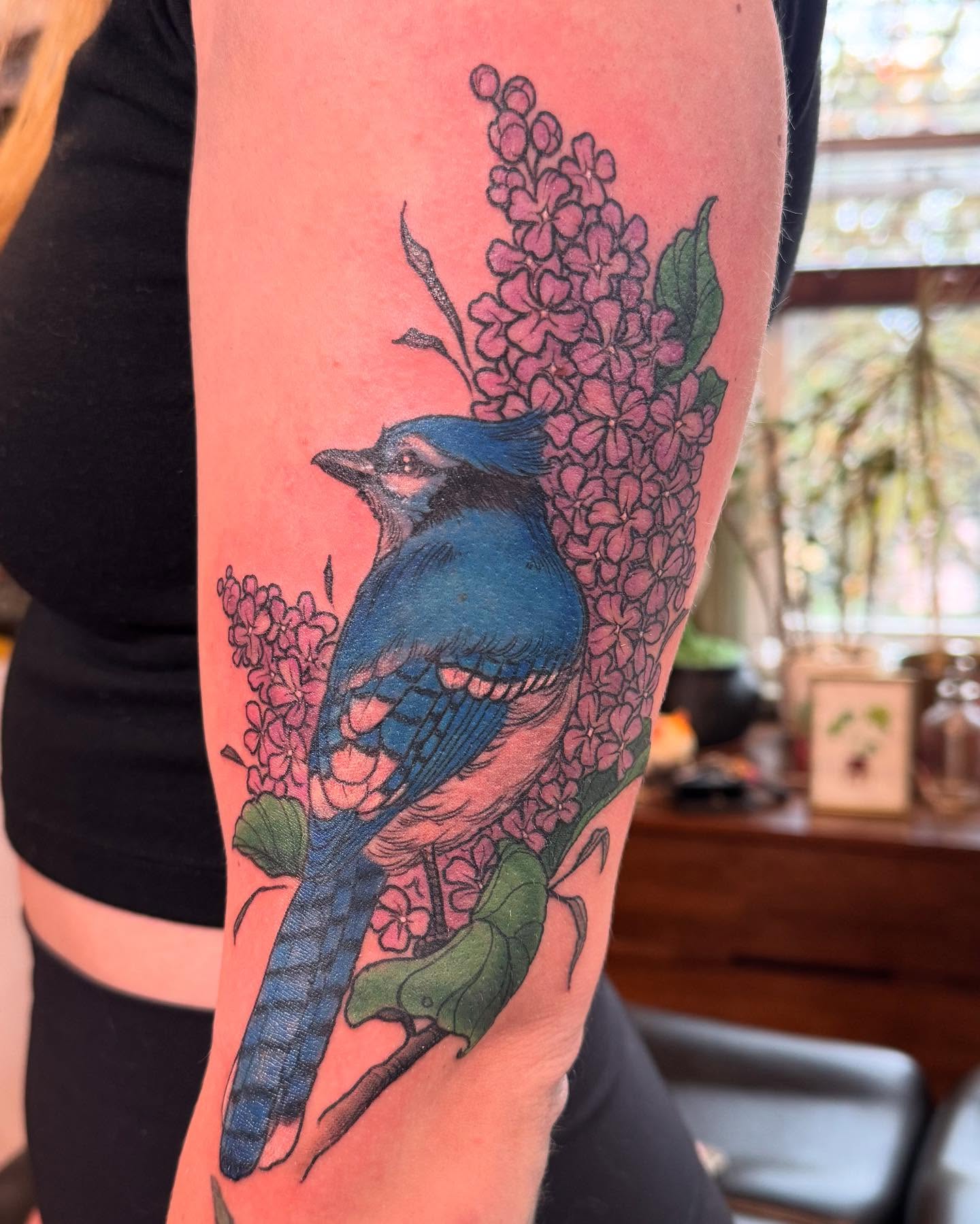 Blue jay and lilacs realism tattoo on the forearm by Rebeka Chase [Sobodacha]