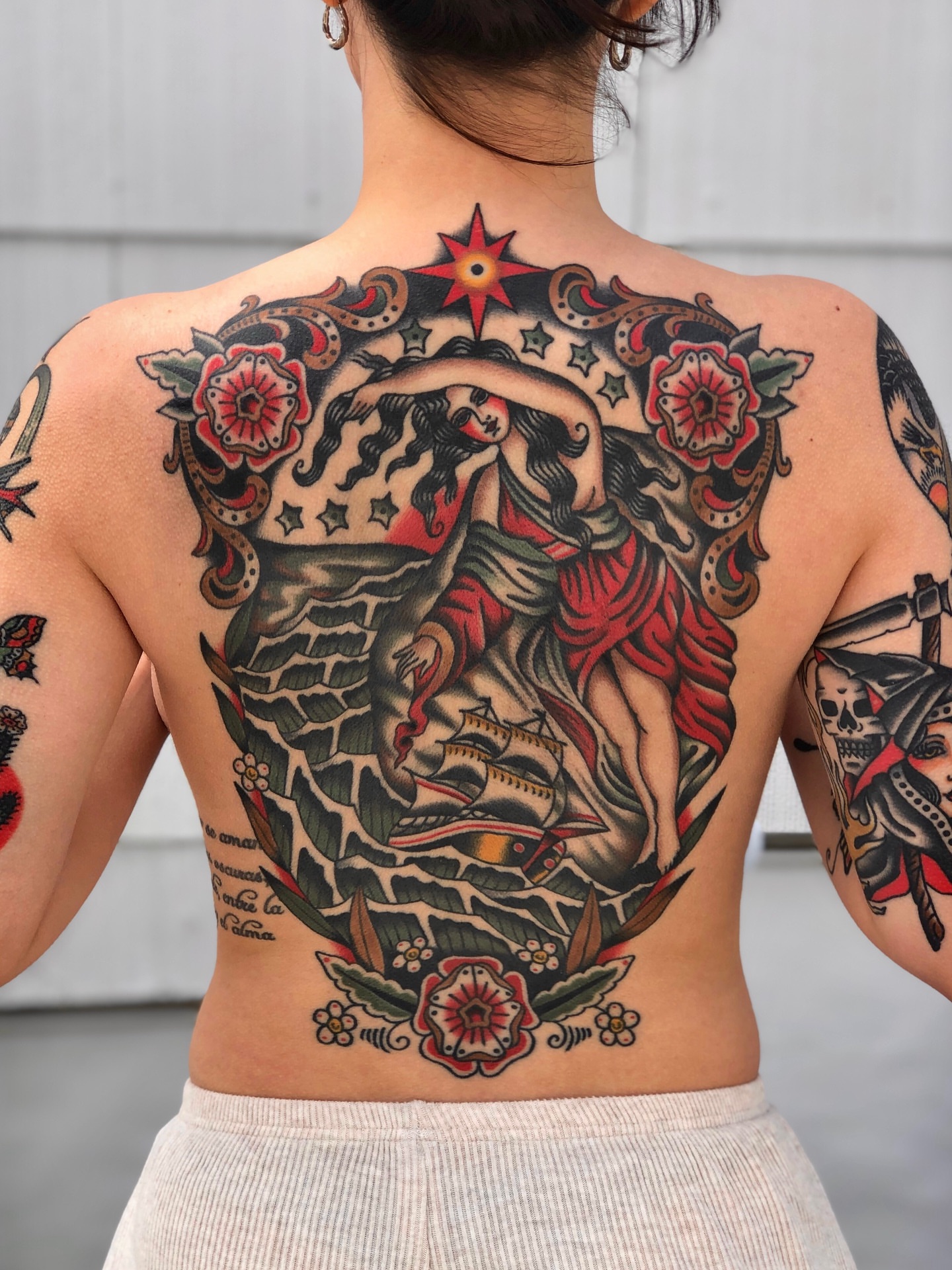 Woman with dragon American traditional tattoo on the back by EVA Traditional Tattoos