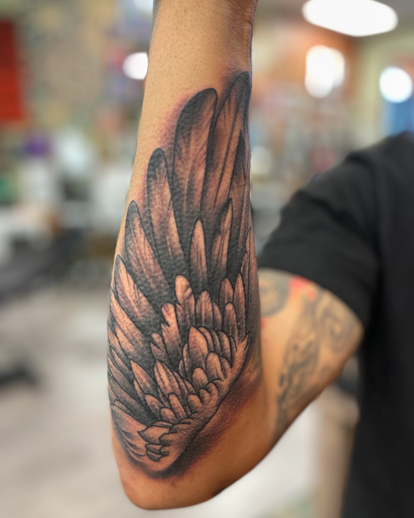 Wing black and grey tattoo on the forearm by Alex