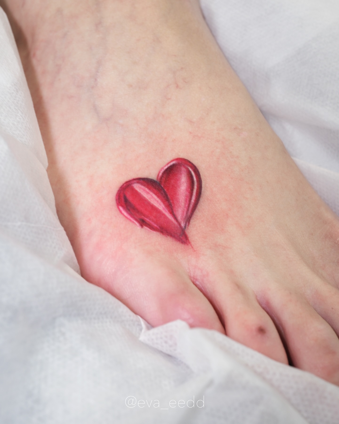 Heart realism tattoo on the foot by Eva Liu