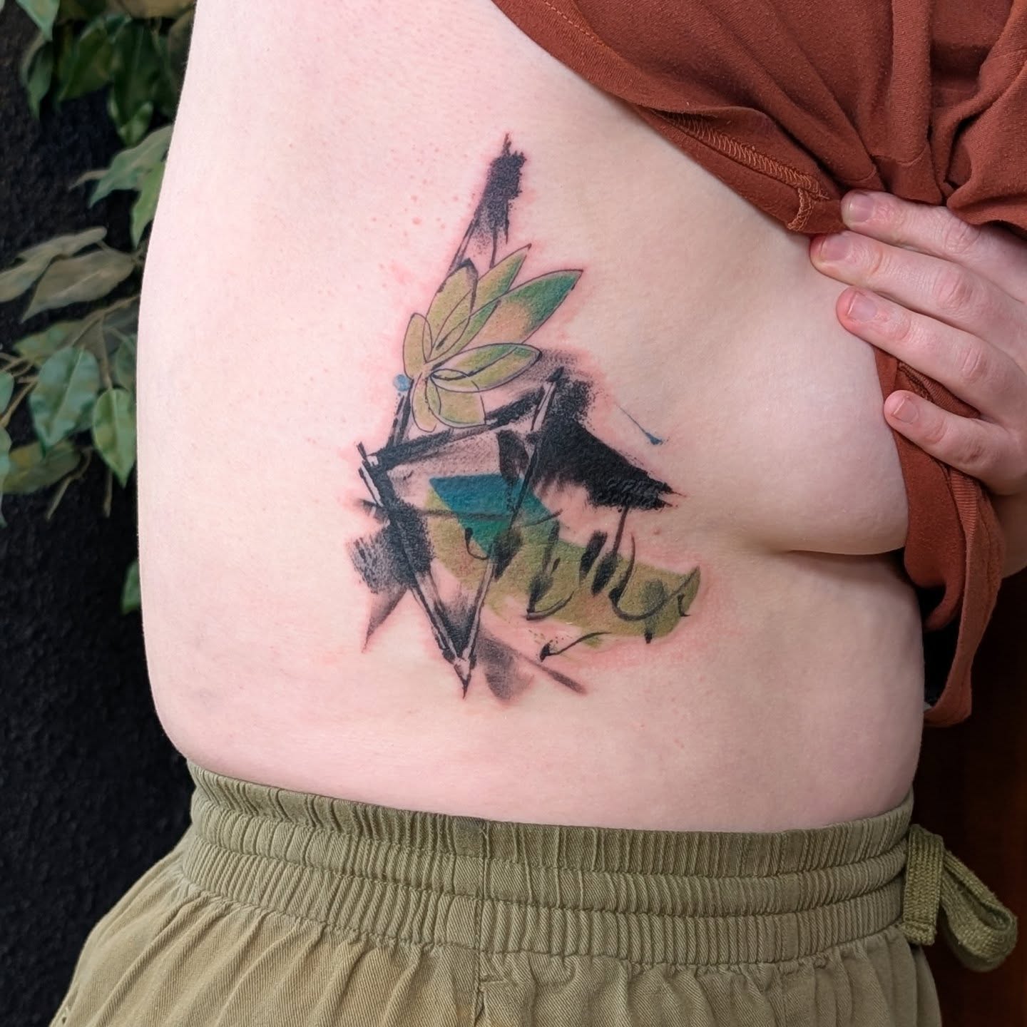 Bird and leaves watercolor tattoo on the ribs by Jhenn