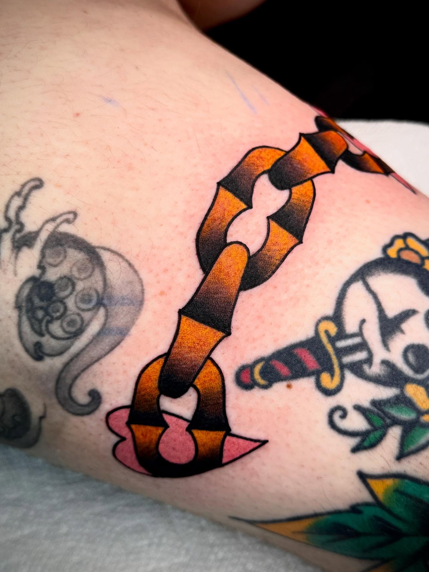 Chain and skull American traditional tattoo on the forearm by Meg Nefcy, Milford, Michigan