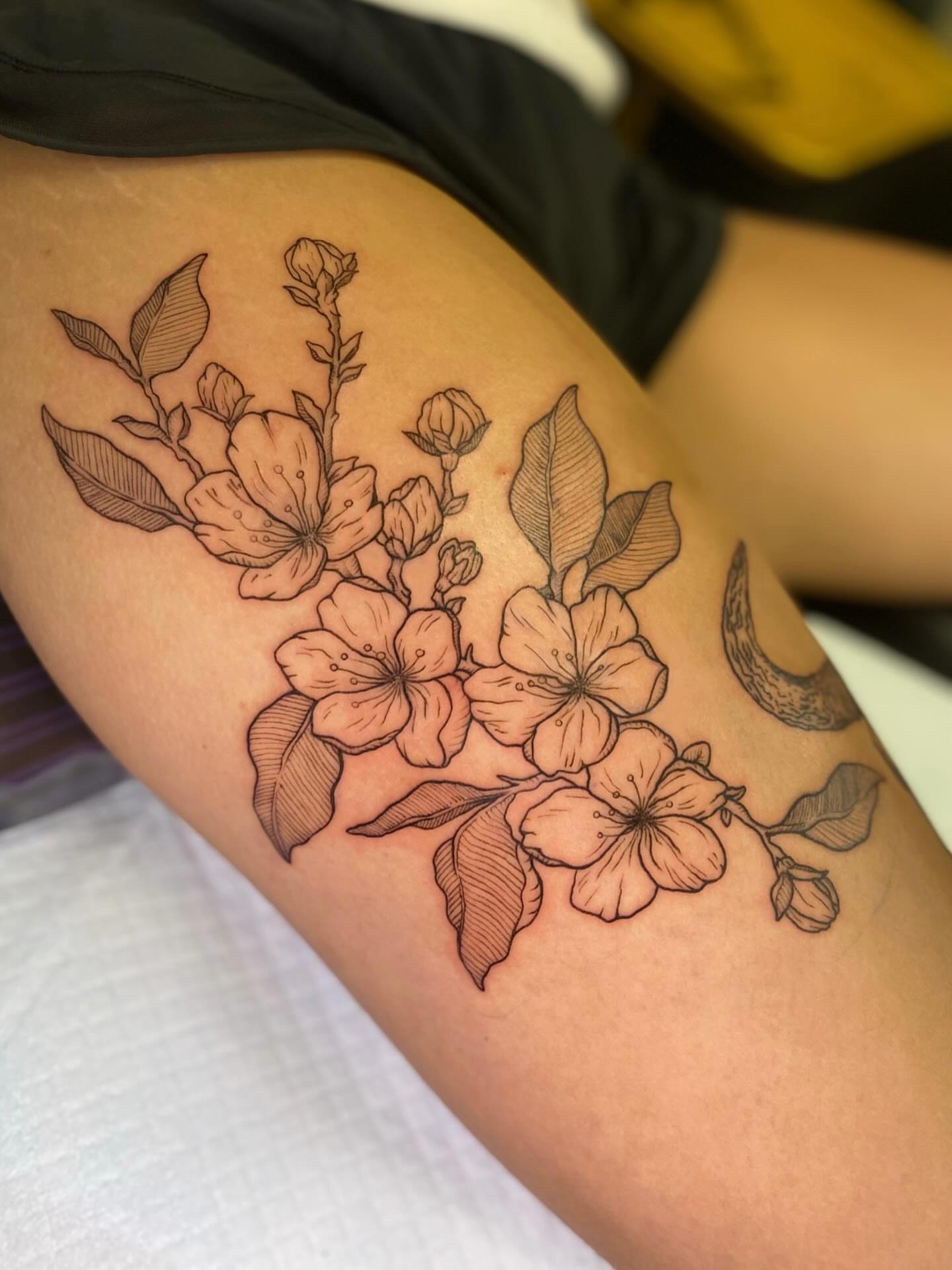 Cherry blossoms black and grey tattoo on the thigh by Tyla Pistak, Seattle, Washington