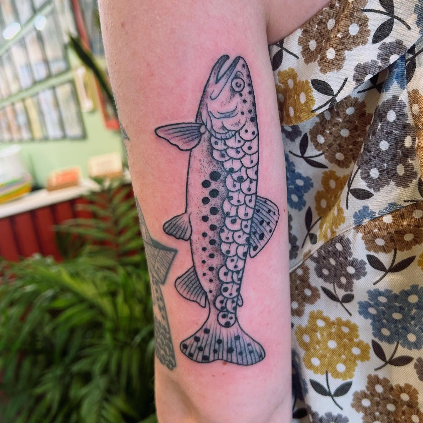 Salmon dotwork tattoo on the forearm by Erica Finley