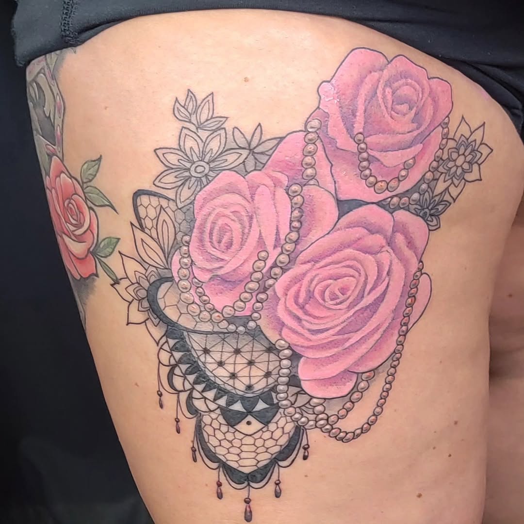 Pink roses and pearls neo-traditional tattoo on the thigh by Hatchetfoot Art
