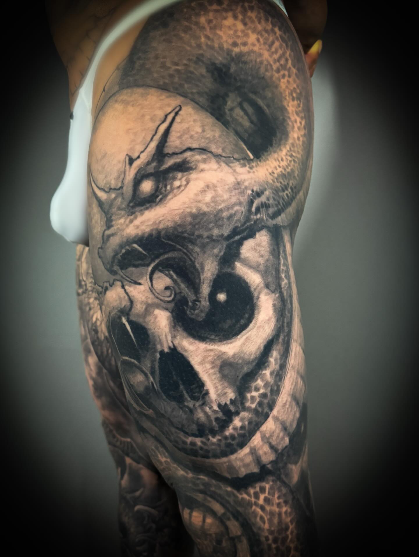 Skull dark realism tattoo on the forearm by Paul Booth