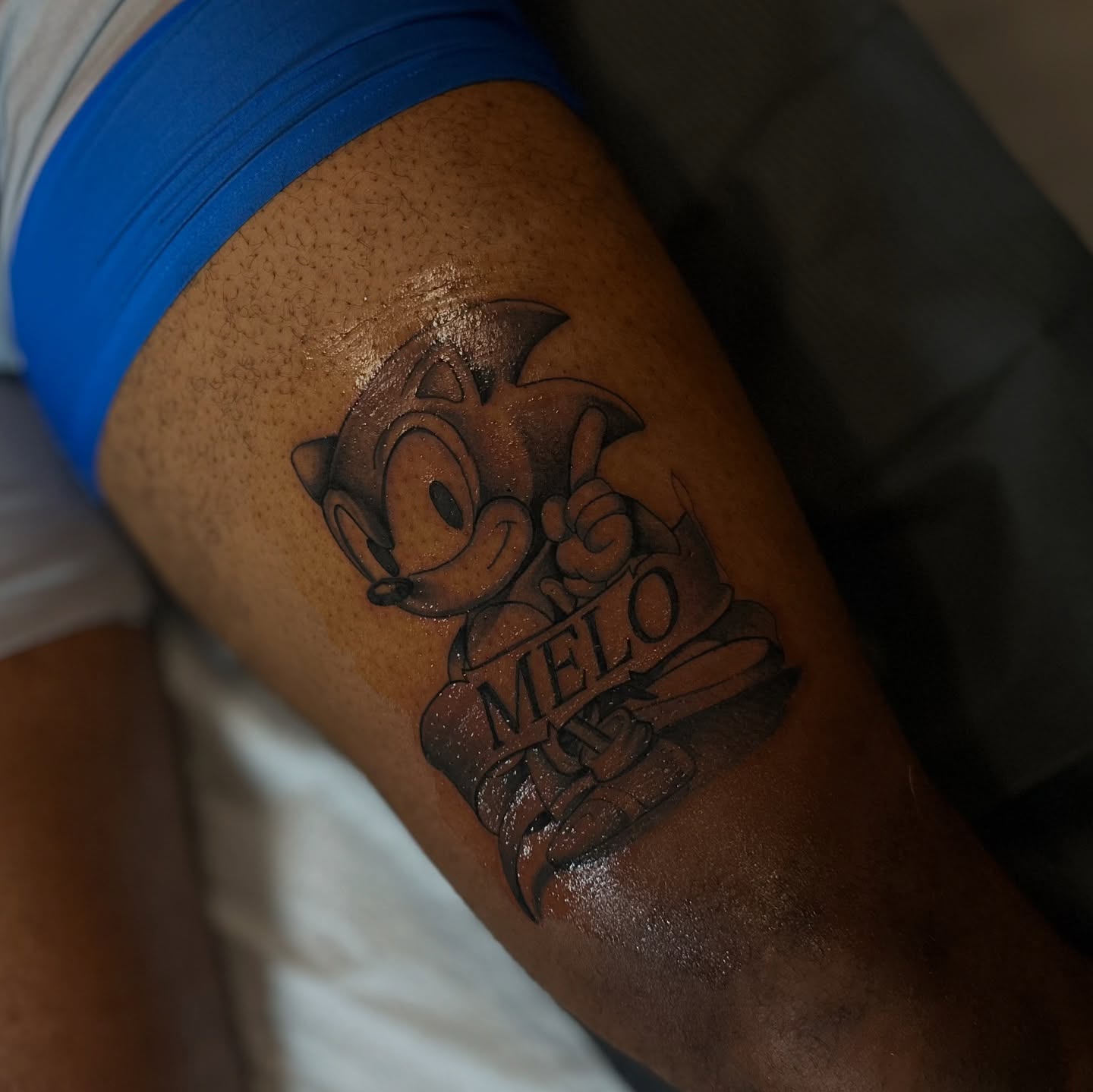 Sonic the hedgehog black and grey tattoo on the thigh by mssinderella