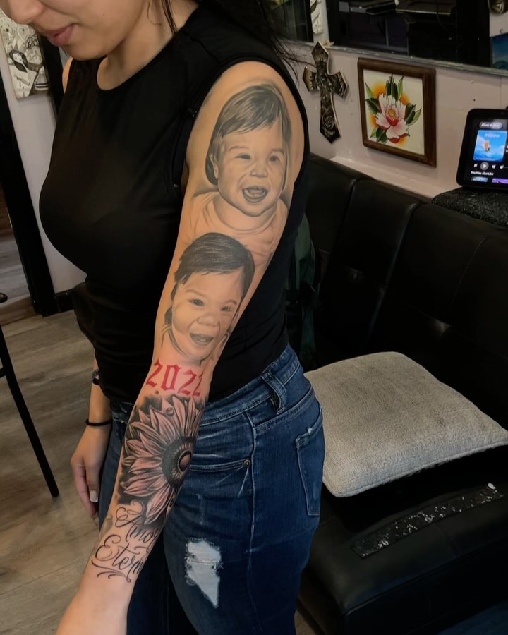 Child's face realism tattoo on the forearm by michael