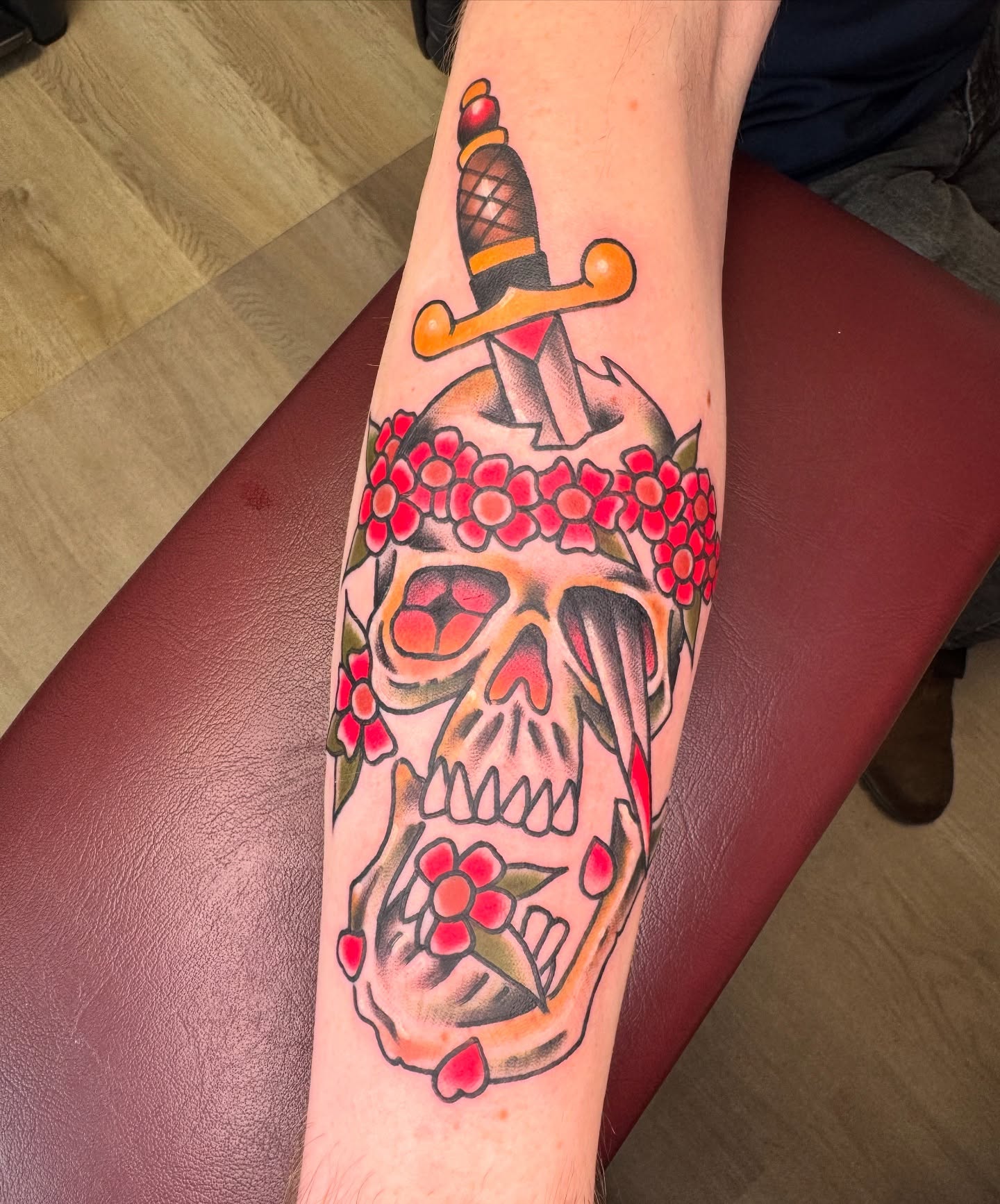 Skull with dagger American traditional tattoo on the forearm by Jeremy Hudson