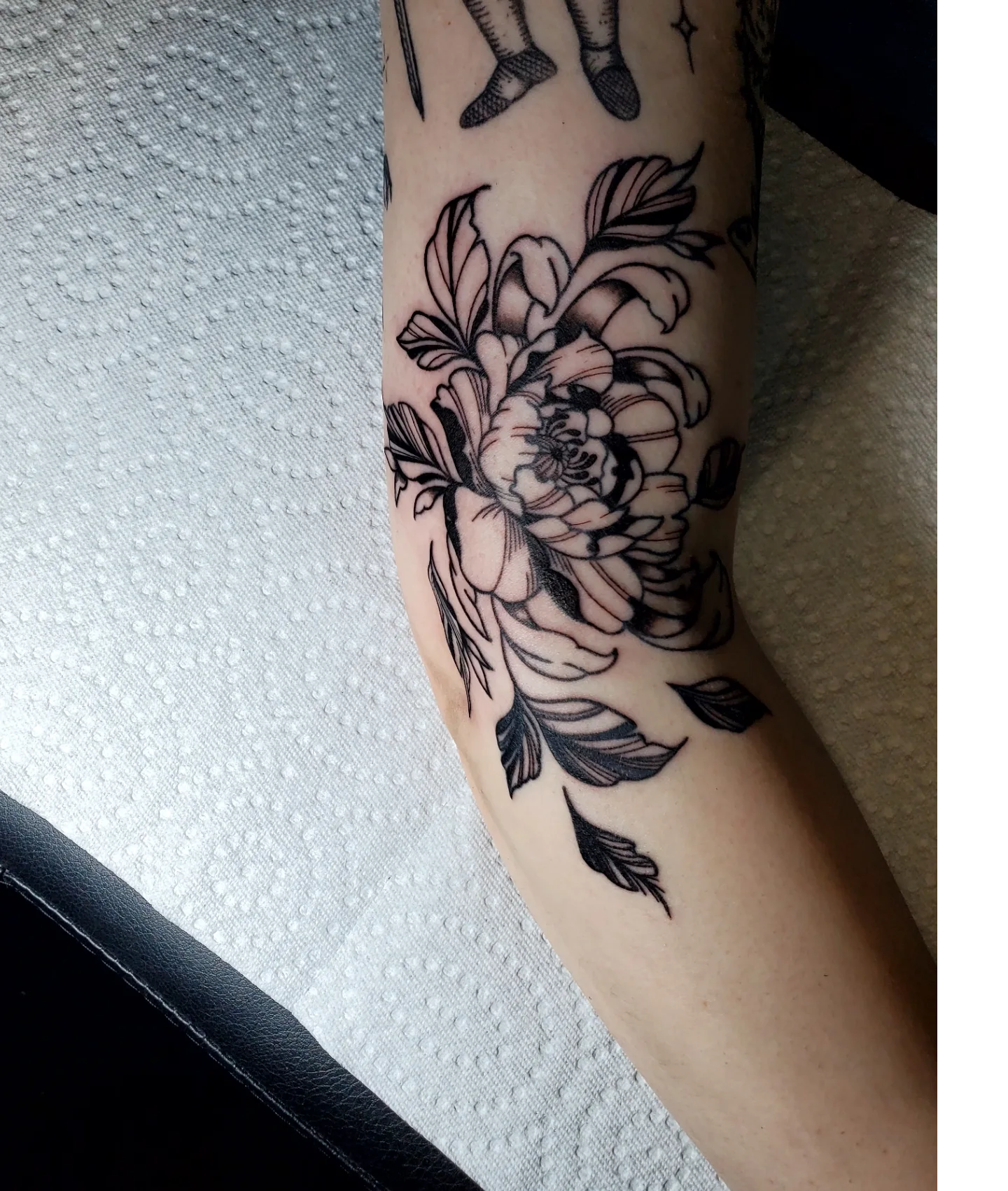 Peony black and grey tattoo on the forearm by Shailey Pasquale