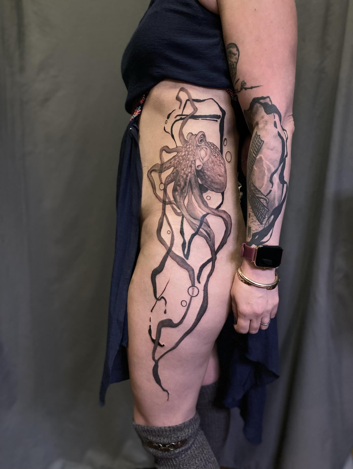 Octopus black and grey tattoo on the thigh by Dana Jones