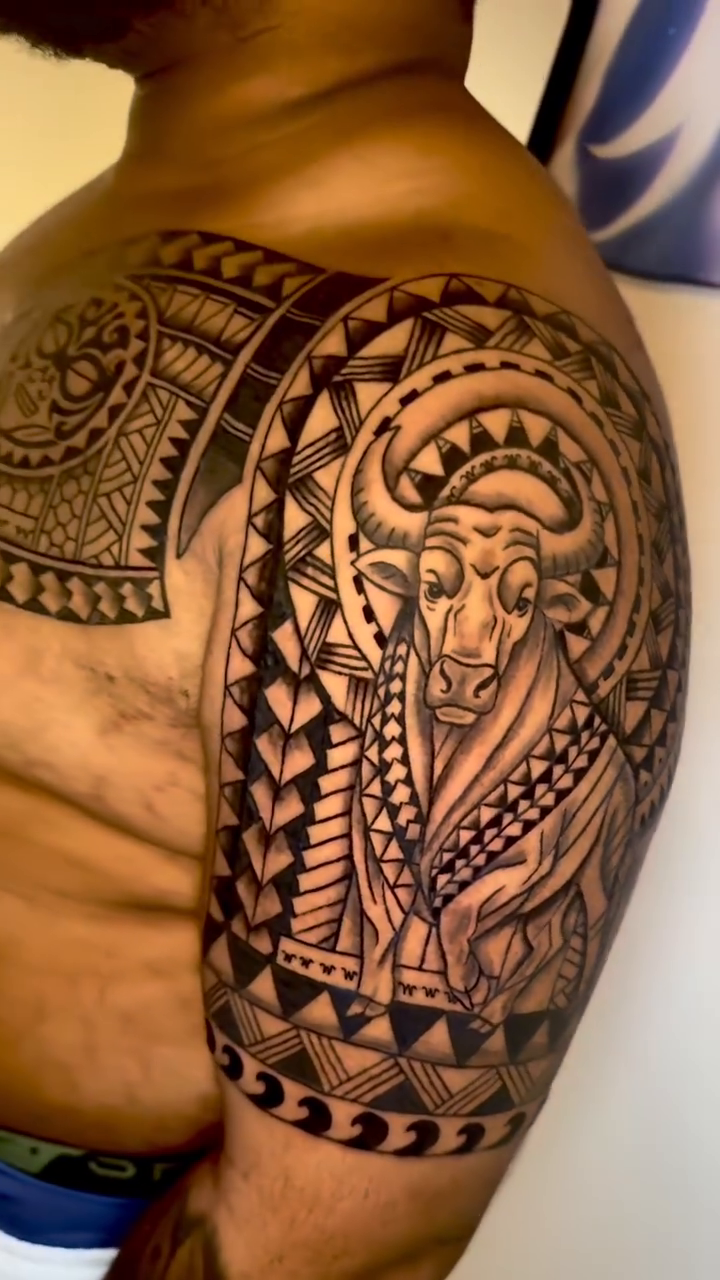 Bull and tribal patterns tribal tattoo on the upper arm by Ivy lee