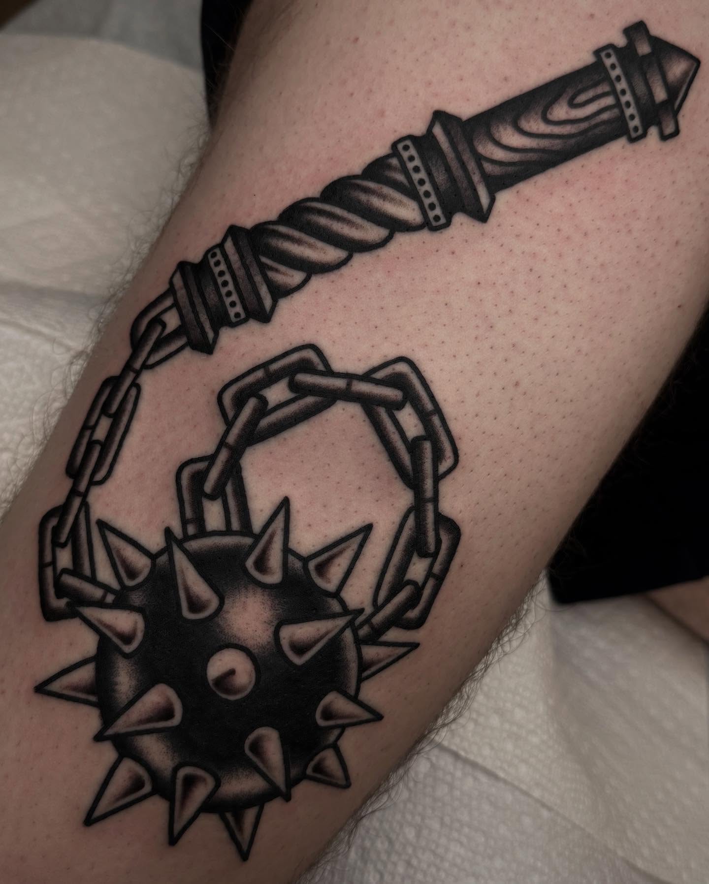 Spiked ball and chain black and grey tattoo on the forearm by John Lemon