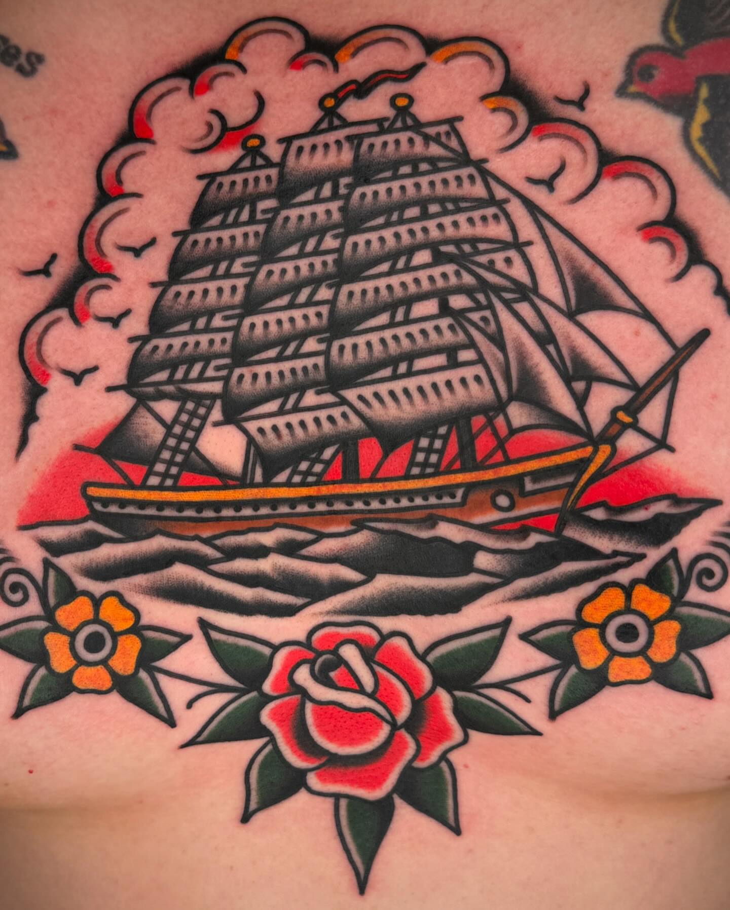Ship and roses American traditional tattoo on the chest by John Lemon