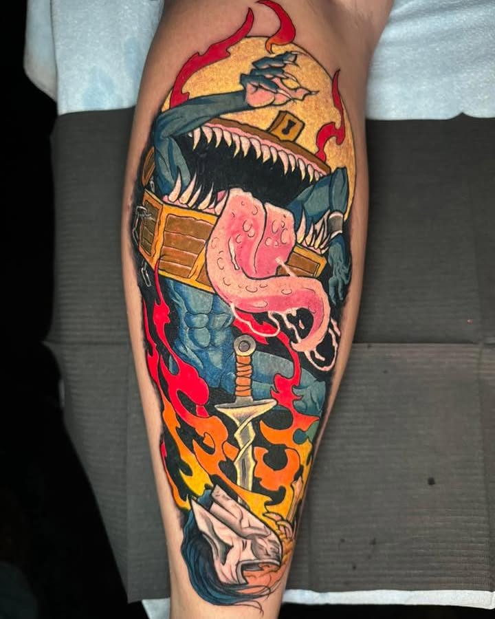 Dragon and sword American traditional tattoo on the calf by Bobby Hurst