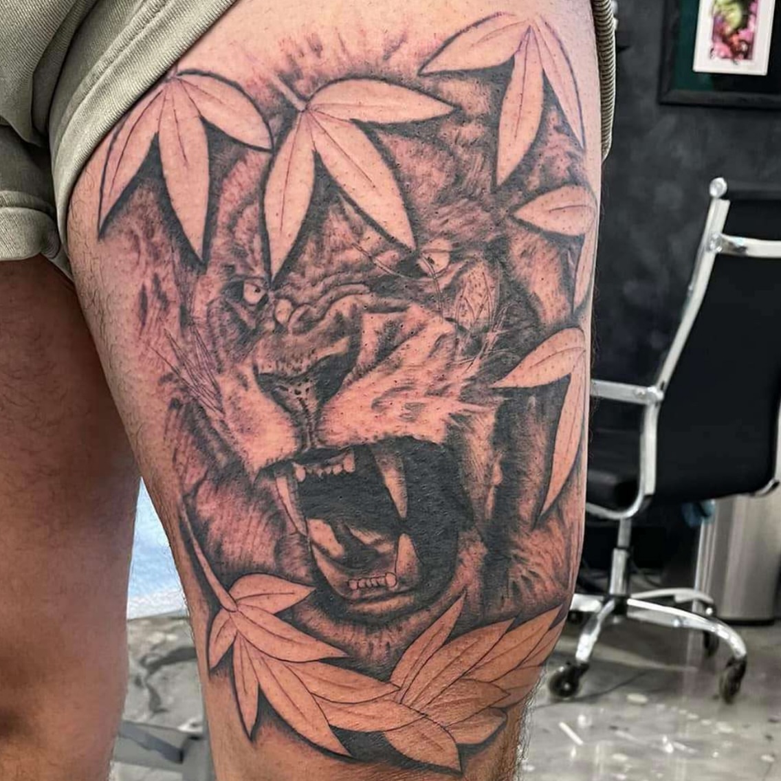 Lion realism tattoo on the thigh by Brandon Anderson