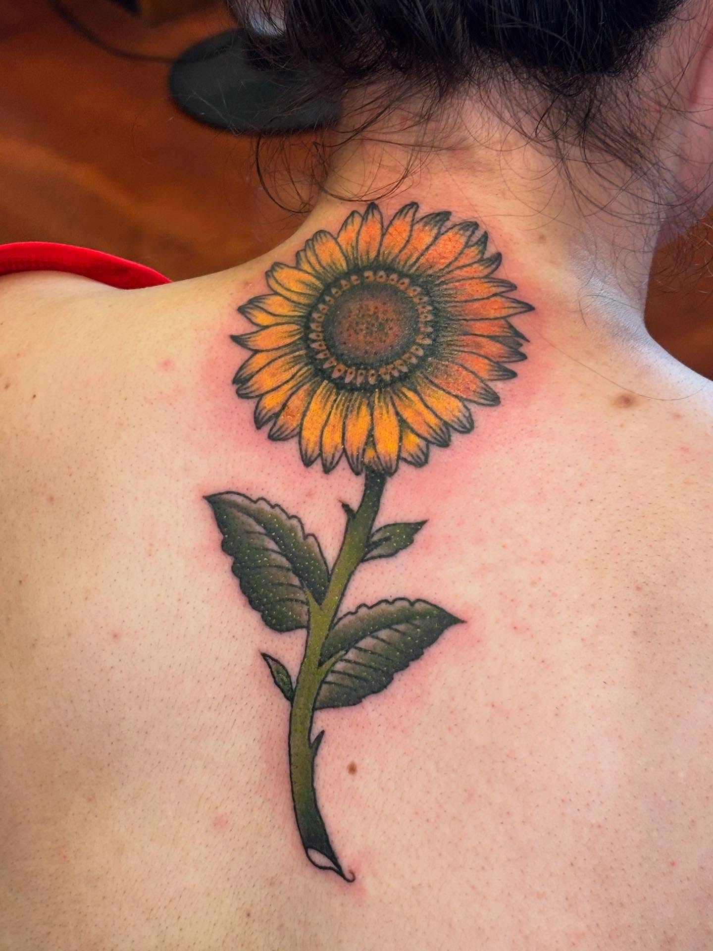 Sunflower realism tattoo on the back by Angie Isbell