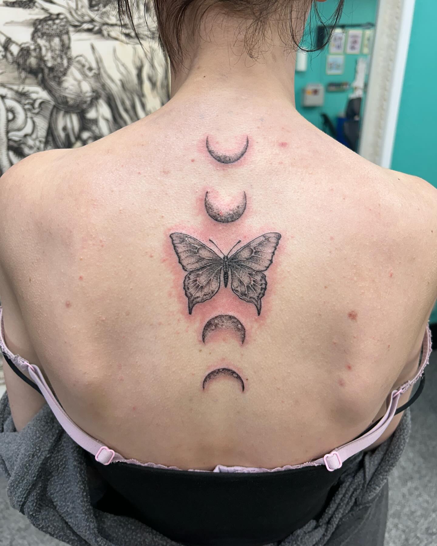 Butterfly and moons black and grey tattoo on the back by Jayda Shell