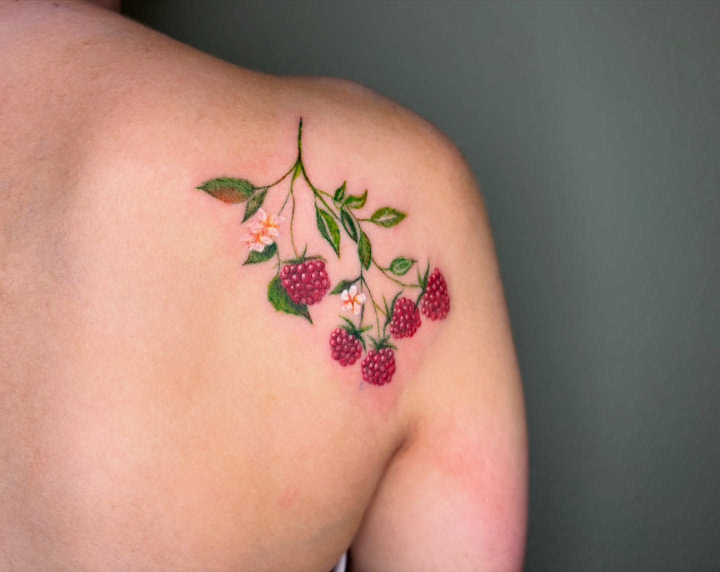 Raspberries and leaves realism tattoo on the shoulder by @miffythereaper