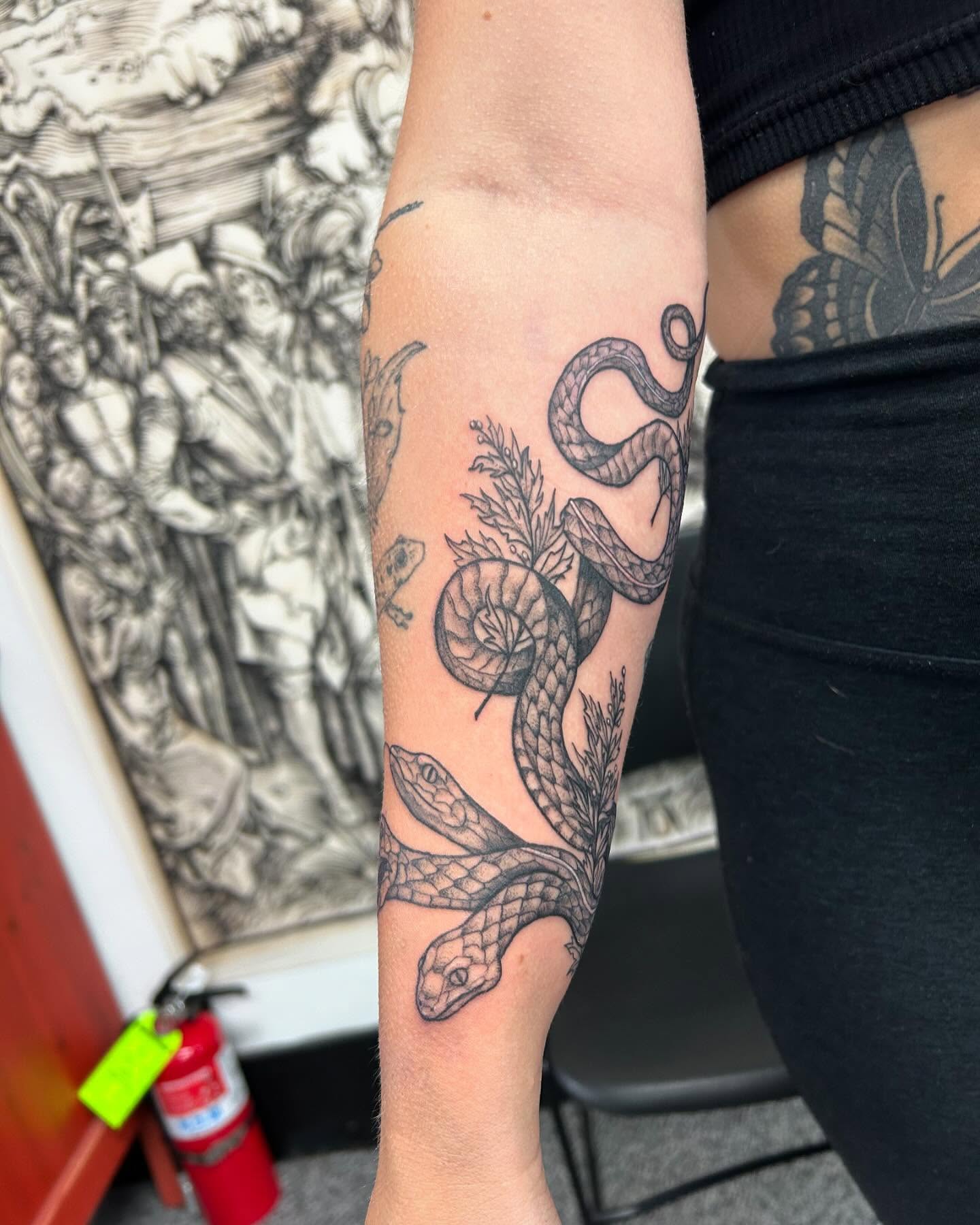 Snake black and grey tattoo on the forearm by Jayda Shell