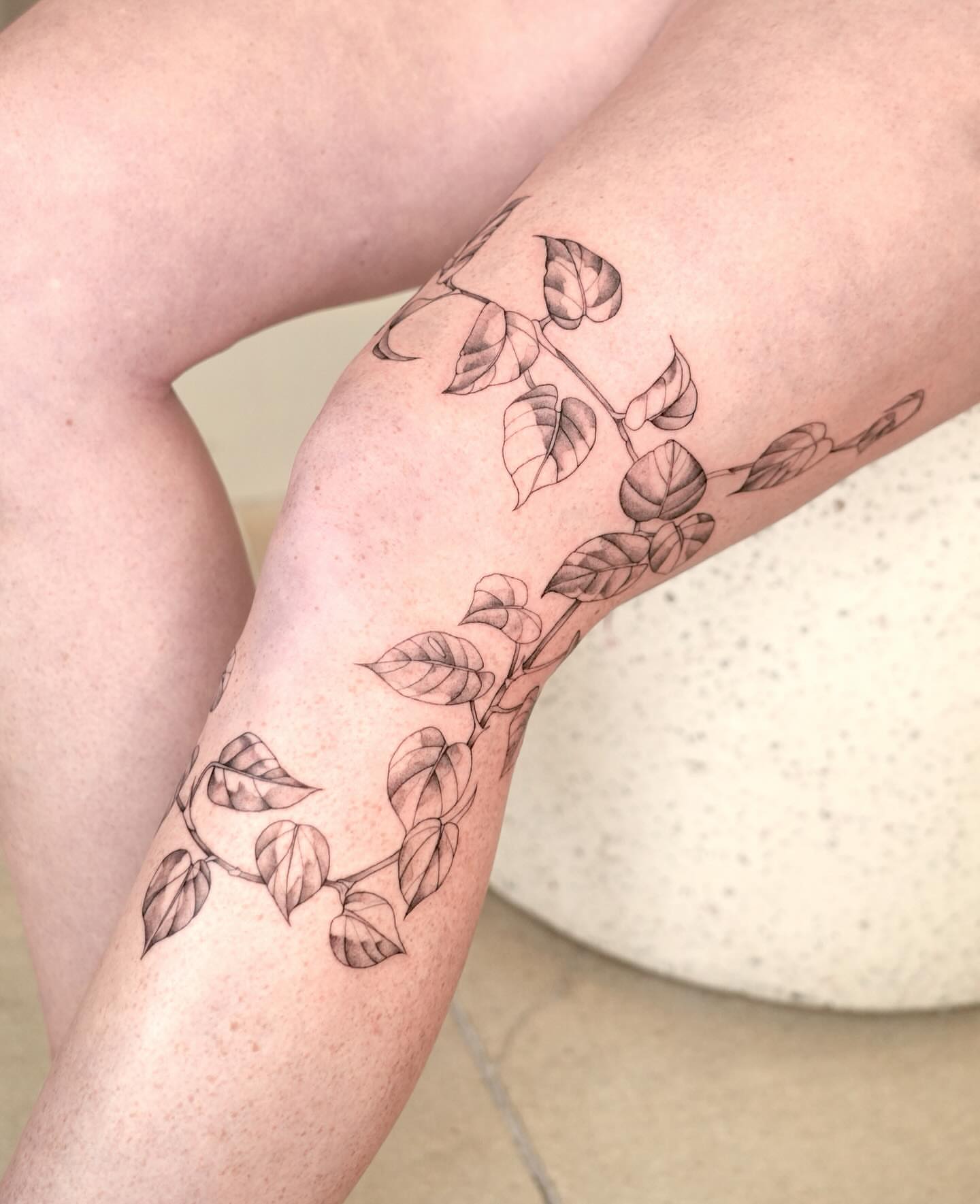 Leaf vine black and grey tattoo on the leg by Marianna D D King