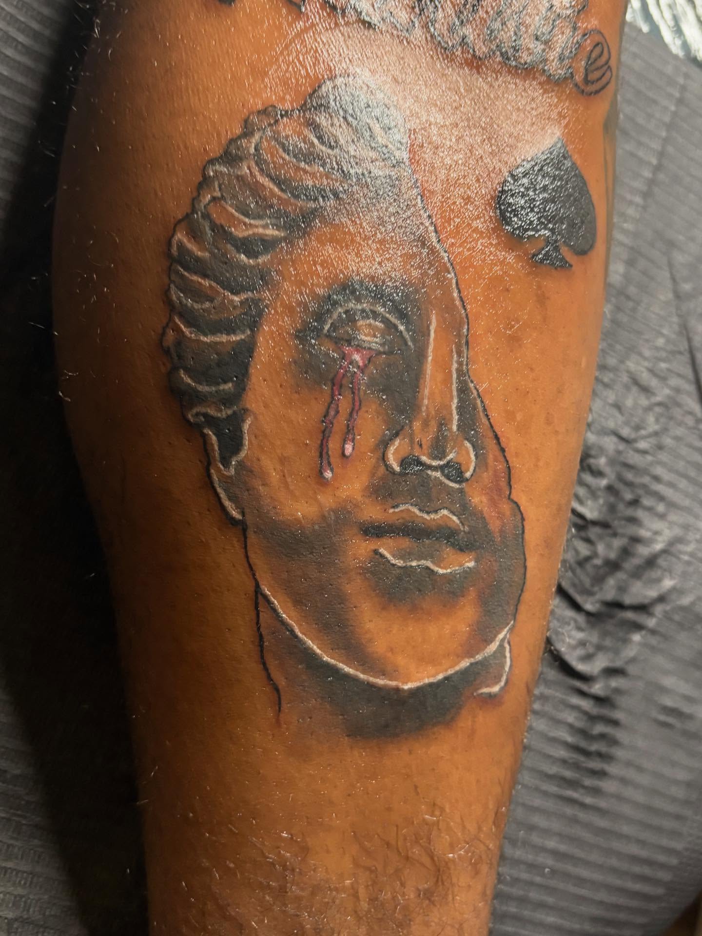 Man's face realism tattoo on the forearm by Illuminink.gallery