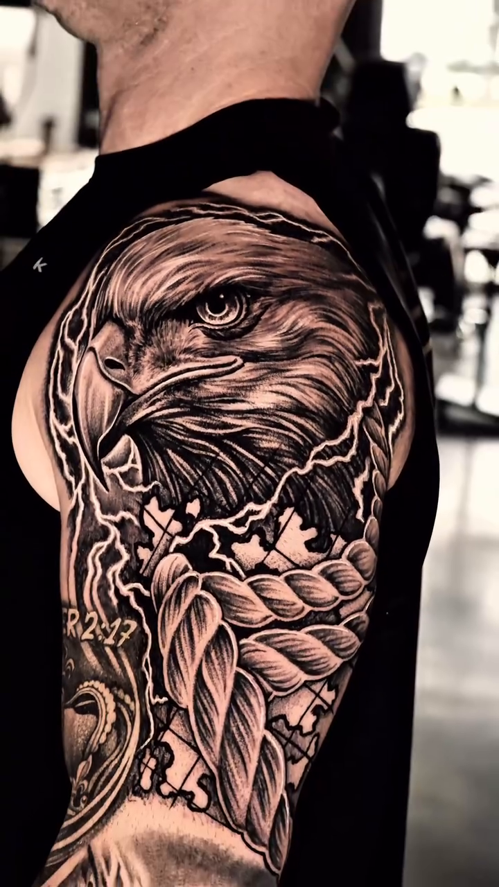 Eagle and feathers realism tattoo by Jack Alvarado.