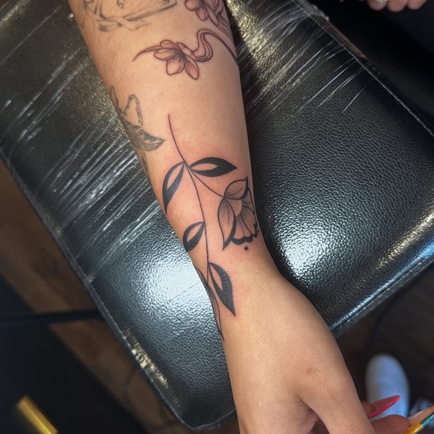 Floral vine dotwork tattoo on the forearm by Priscilla Michels