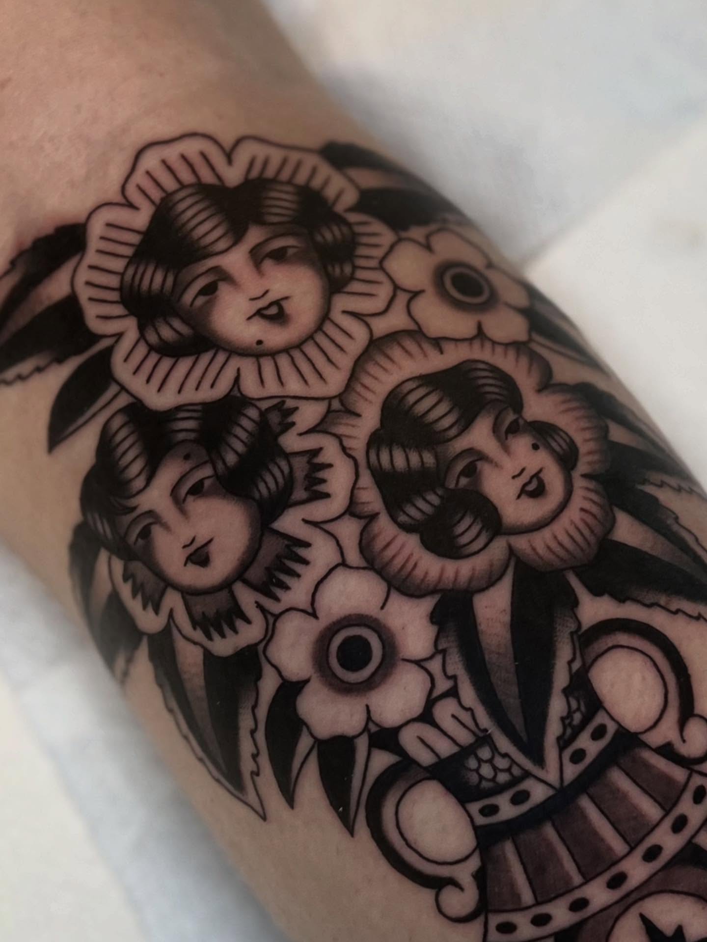 Clowns and flowers American traditional tattoo on the forearm by Syd Sayyah