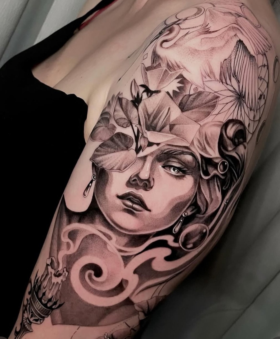 Woman with floral elements realism tattoo on the forearm by Michelle Carlton