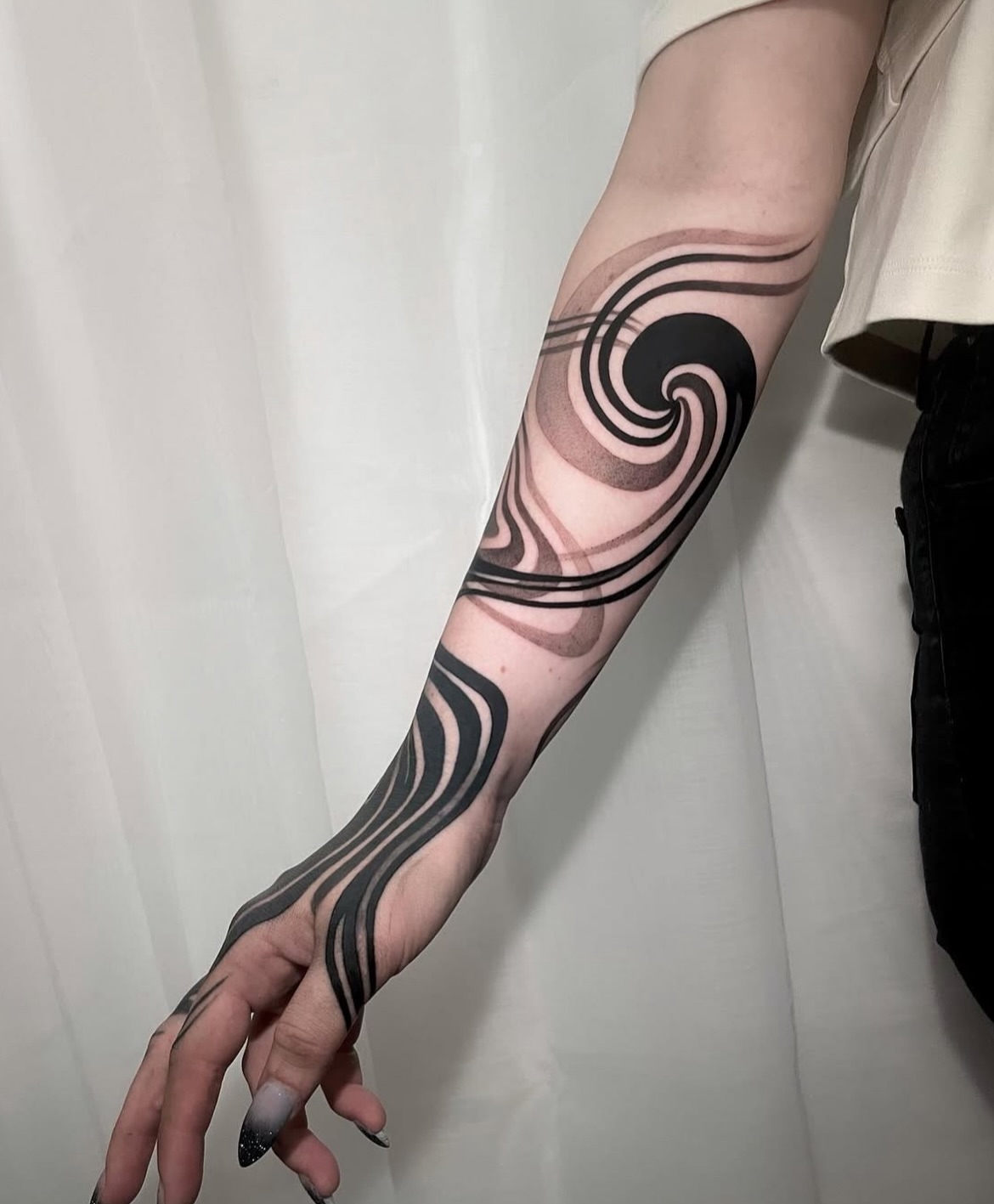 Wave black and grey tattoo on the forearm by Michelle Carlton