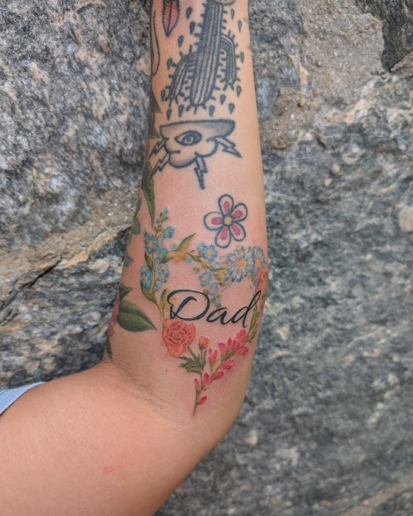 Floral arrangement new school tattoo on the forearm by Cat