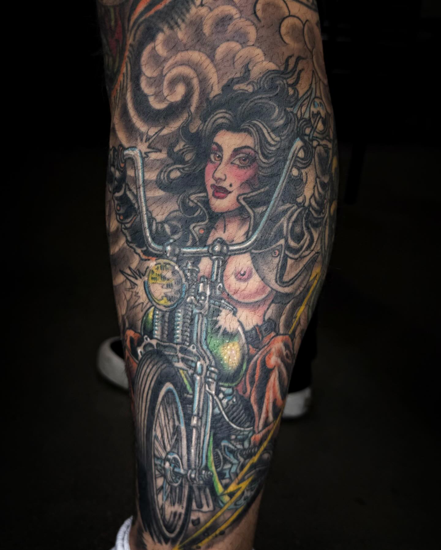Motorcycle pin-up girl American traditional tattoo on the forearm by Adam Warmerdam, Los Angeles, California