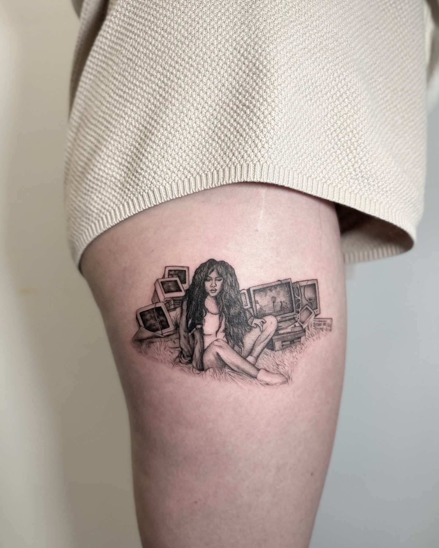 Woman surrounded by monitors realism tattoo on the thigh by Jasmine, Lynnwood, Washington