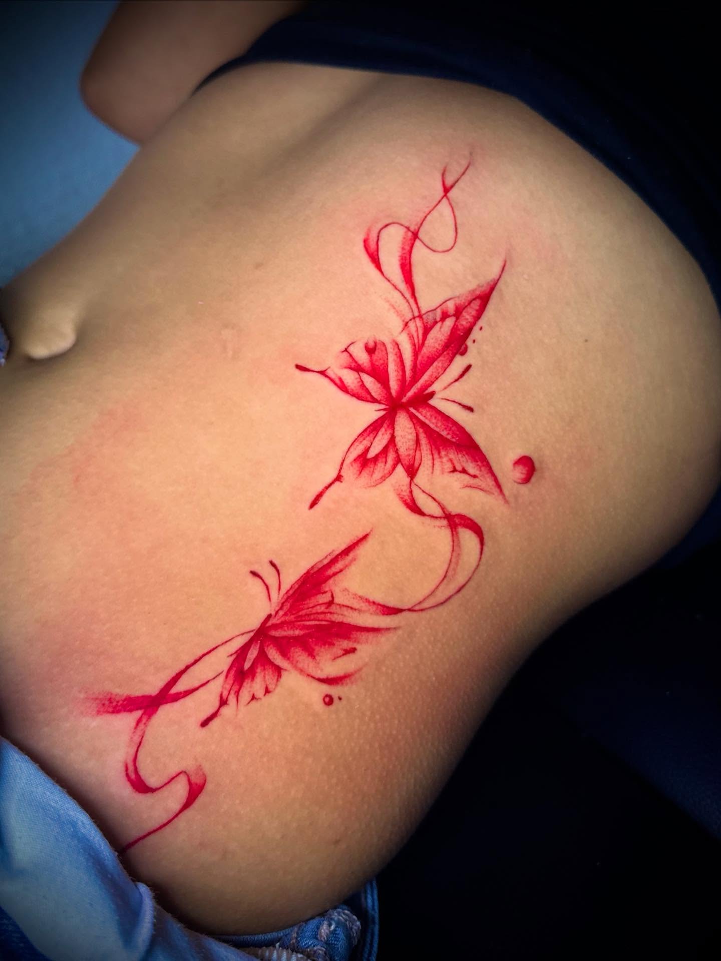 Red floral design new school tattoo by Tattoo Artist based in Dallas Tx
