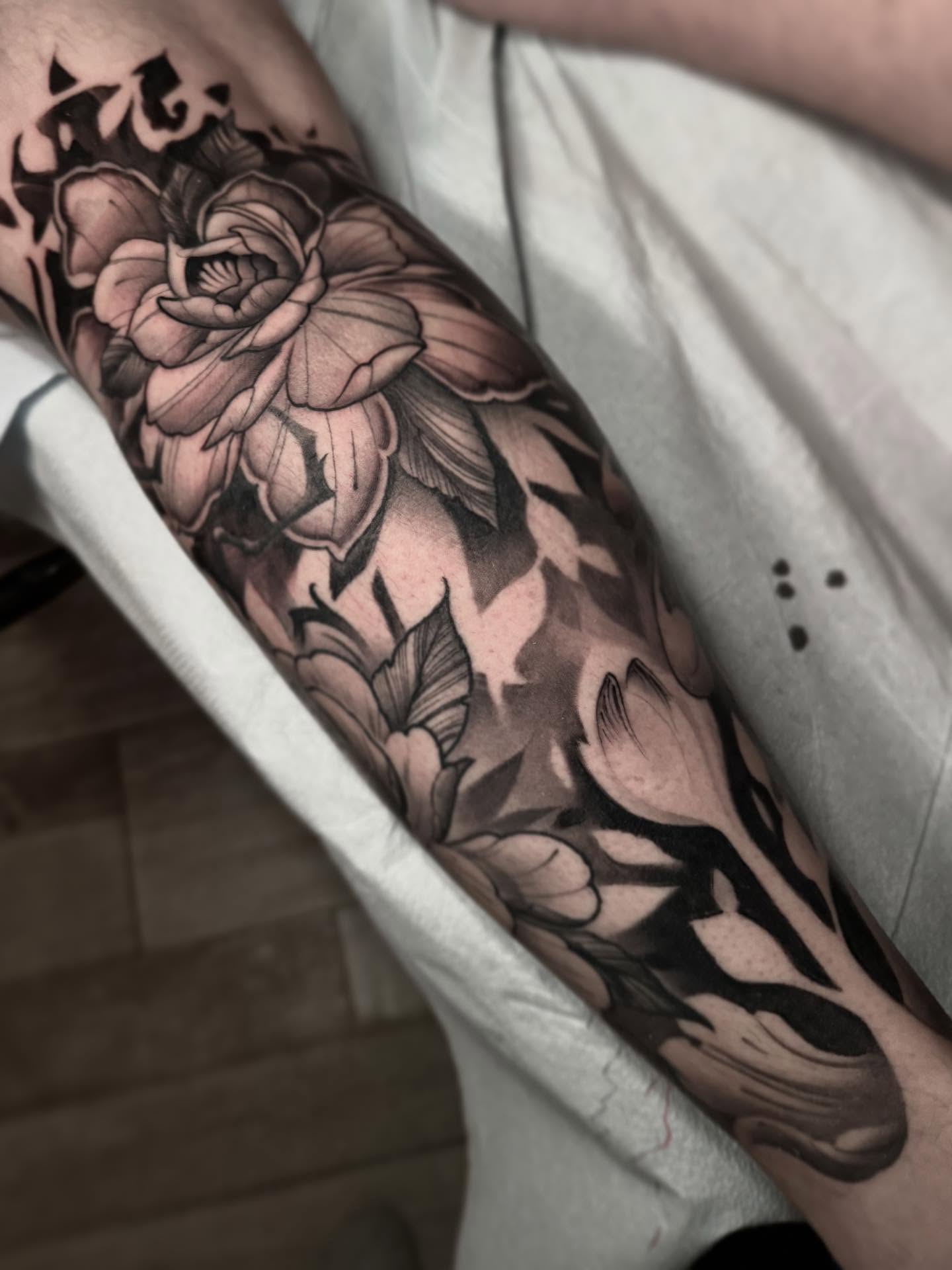 Floral bouquet black and grey tattoo on the forearm by Alex Rockoff