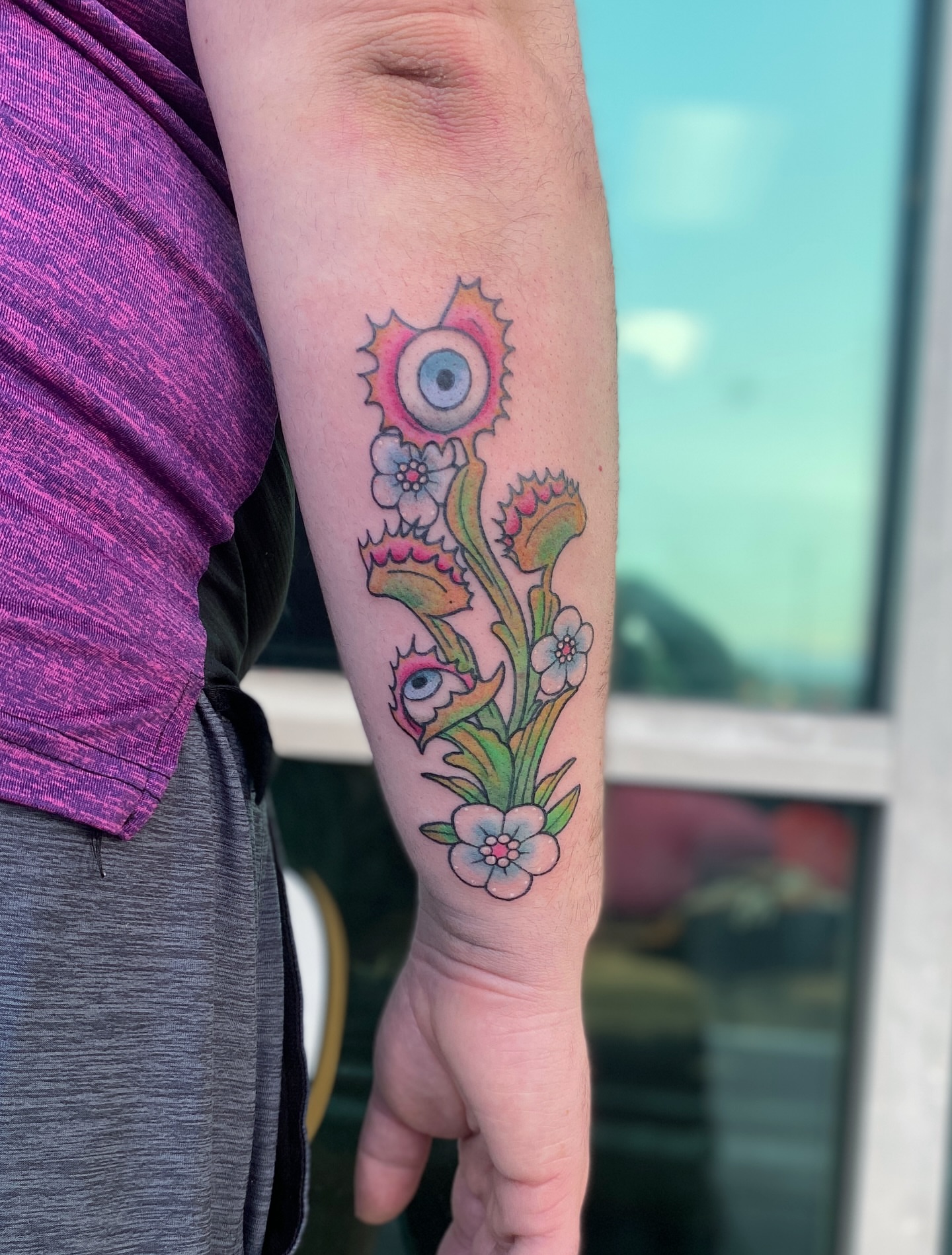 Eye and flowers new school tattoo on the forearm by Elliot Jaye Valentine