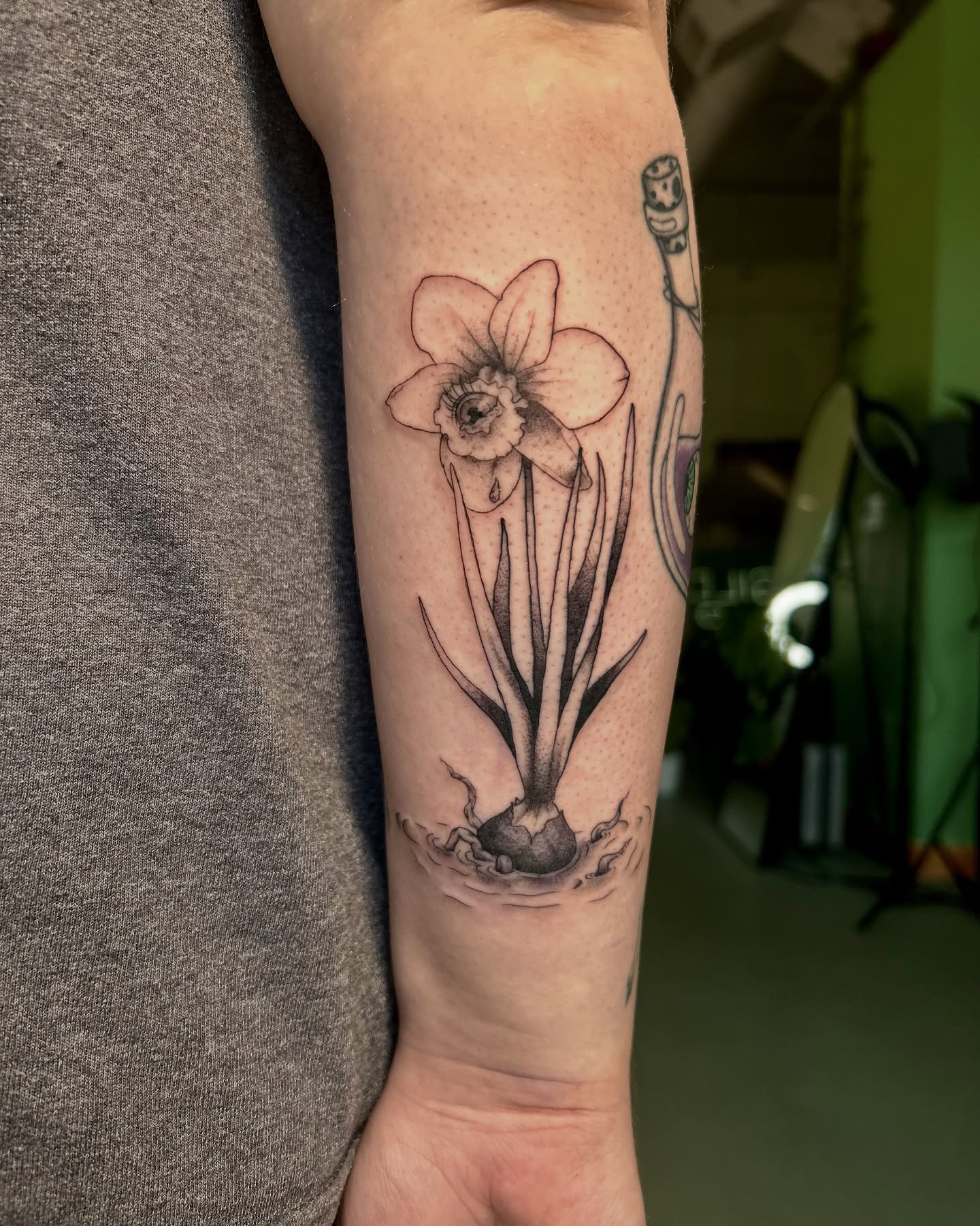 Daffodil black and grey tattoo on the forearm by King By Trade 👑