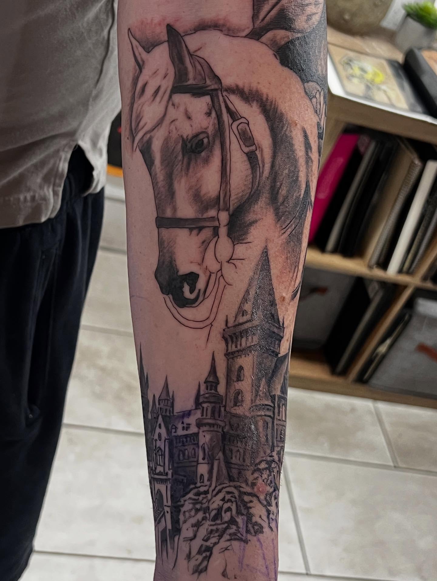 Horse and castle realism tattoo on the forearm by Levi Cox, Powell, Ohio