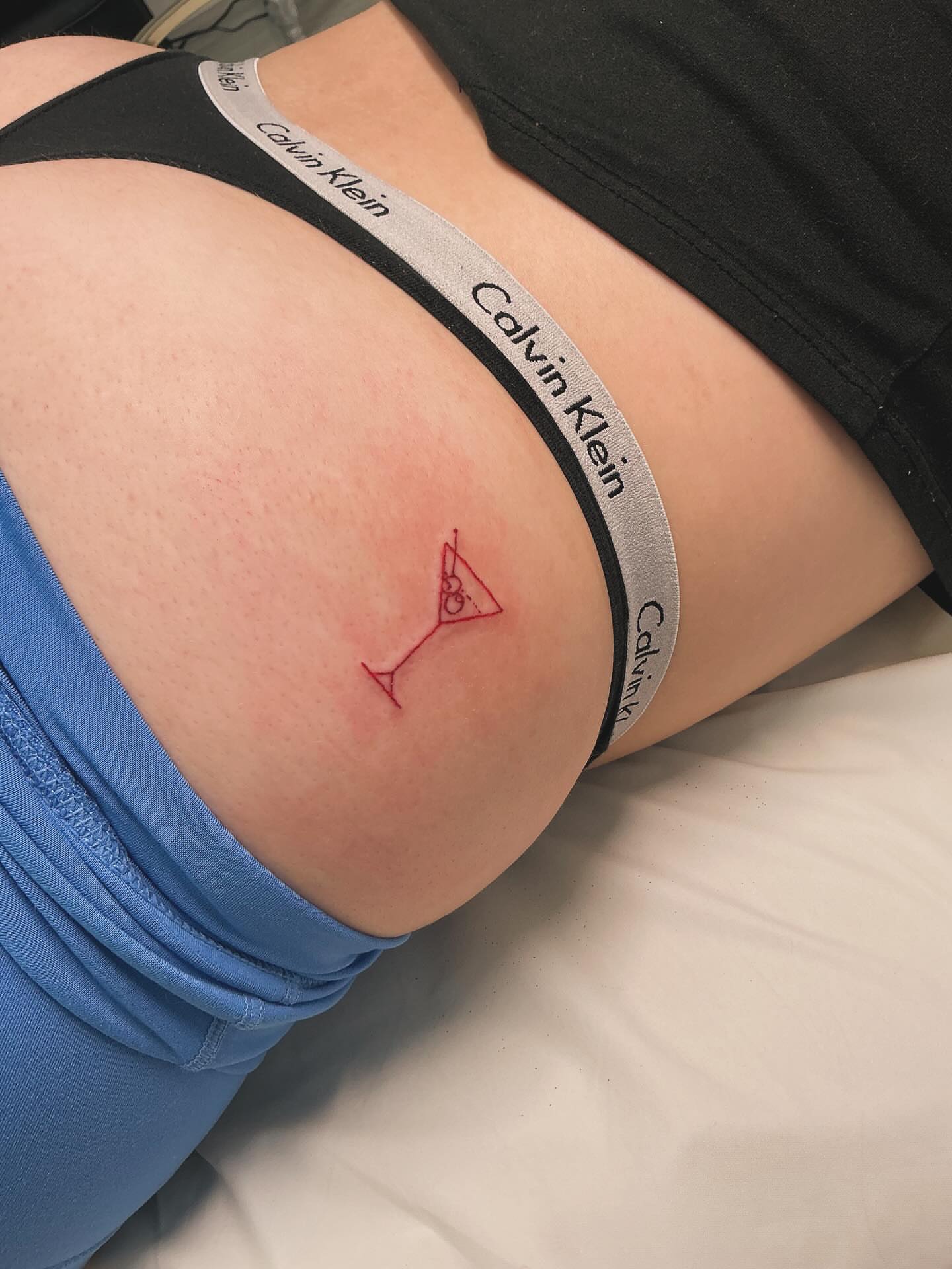 Martini glass geometric tattoo on the thigh by Victoria Cooper