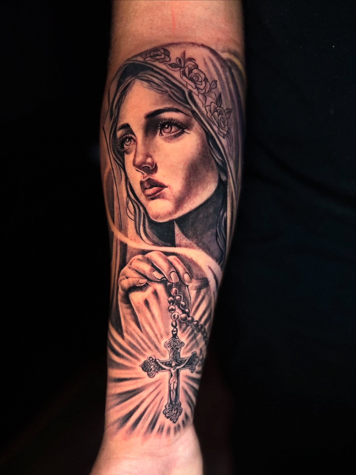 Religious woman with rosary realism tattoo on the forearm by Eric Garcia