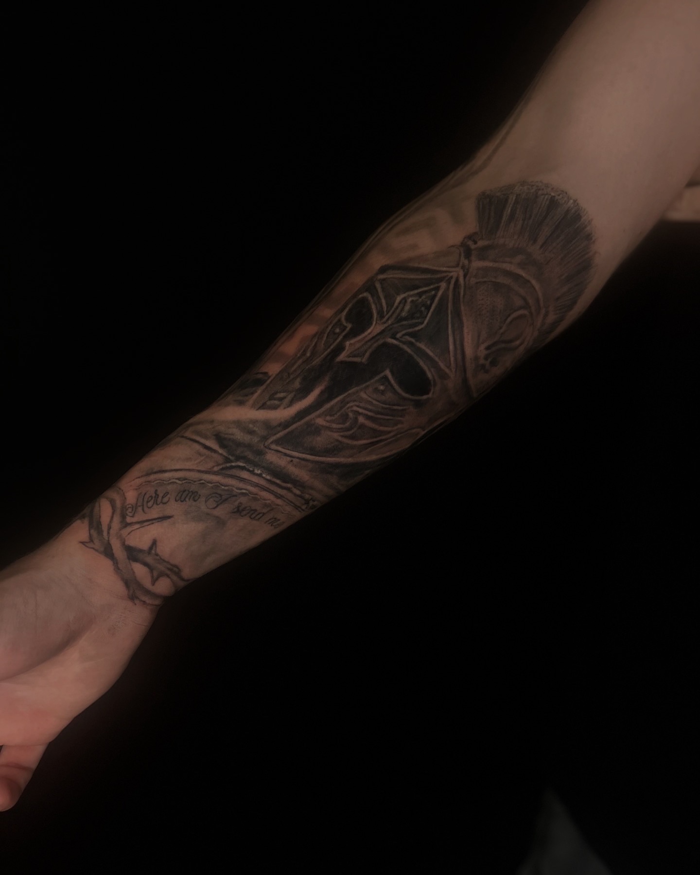 Spartan helmet black and grey tattoo on the forearm by Haley