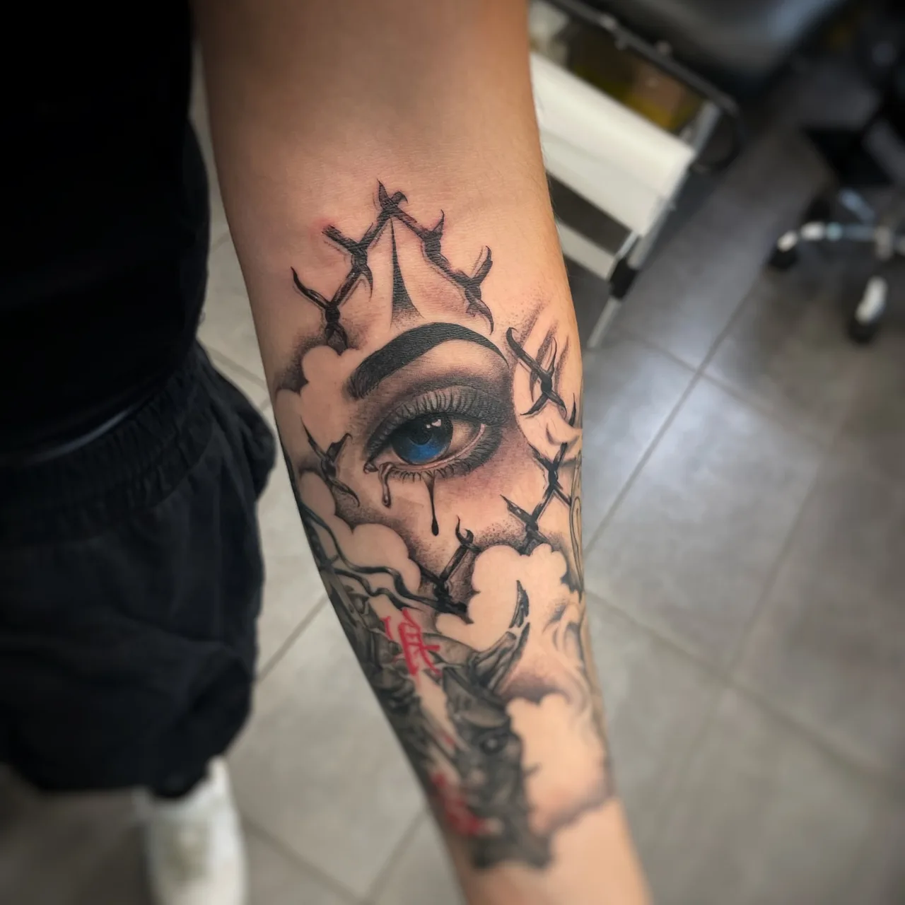 Eye with crown realism tattoo on the forearm by Blot_Tattoo