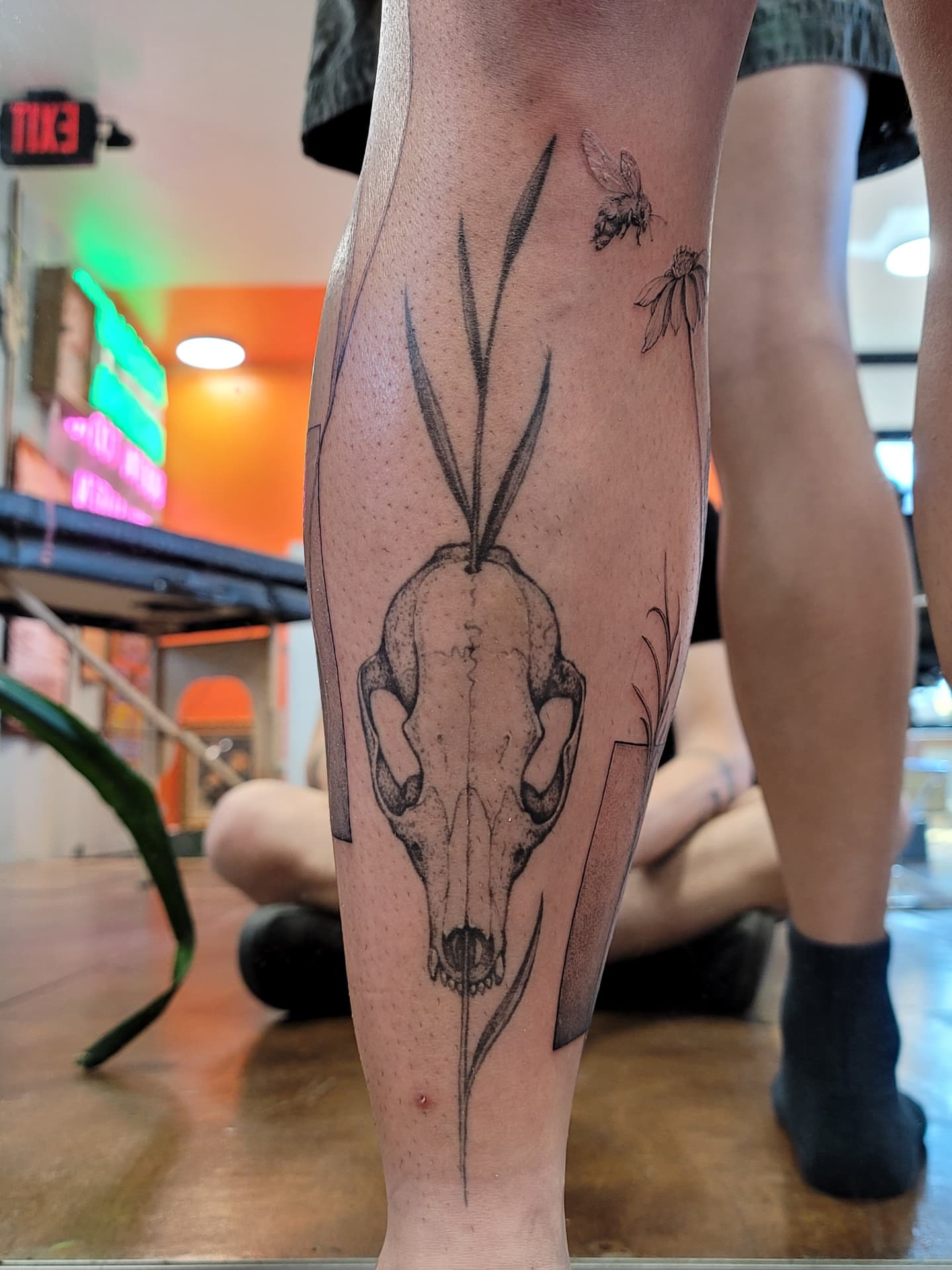 Skull with rabbit ears dotwork tattoo on the calf by Keith Countryman, Fort Worth, Texas