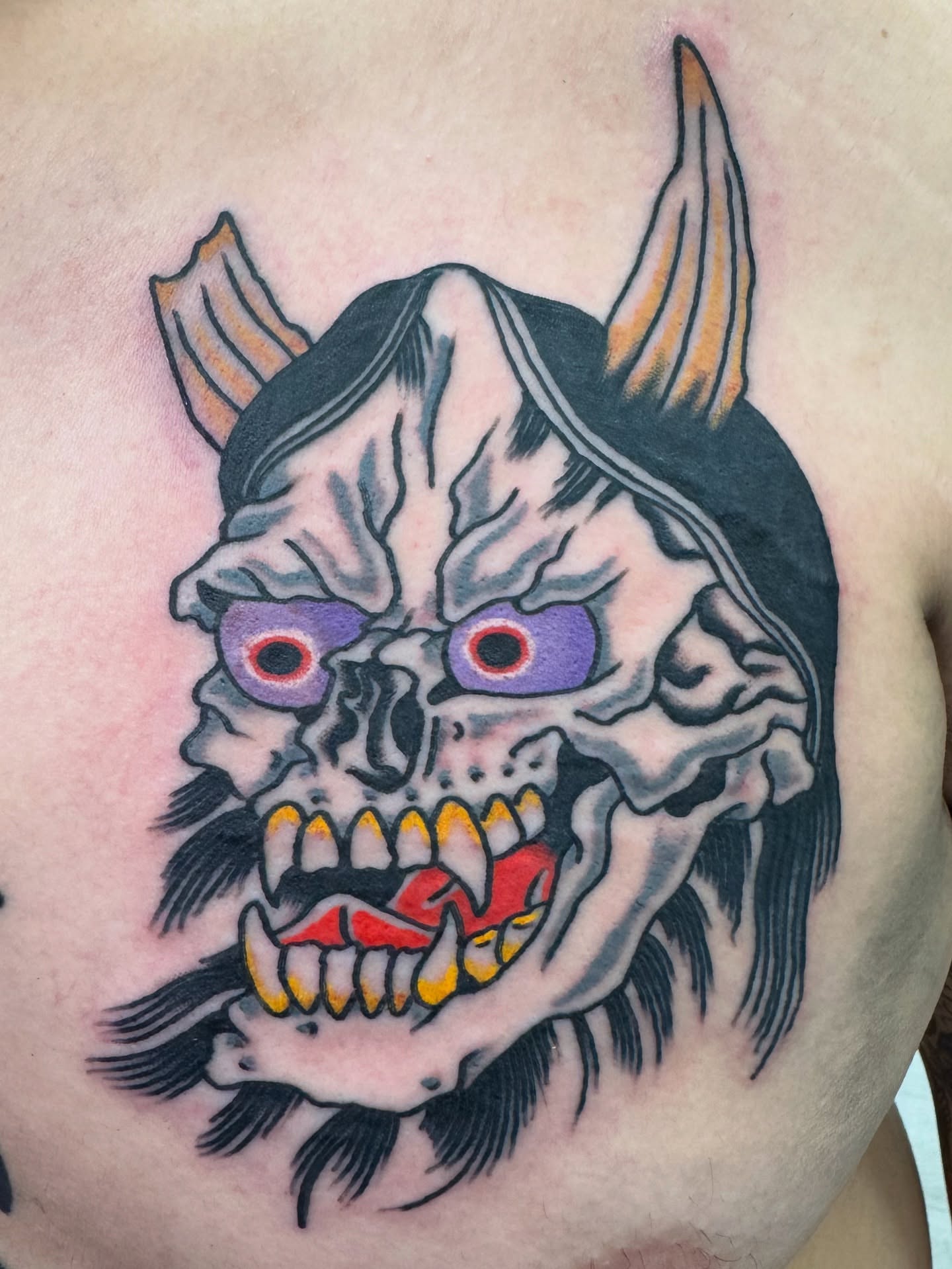 Demon skull American traditional tattoo on the chest by Timothy Wood