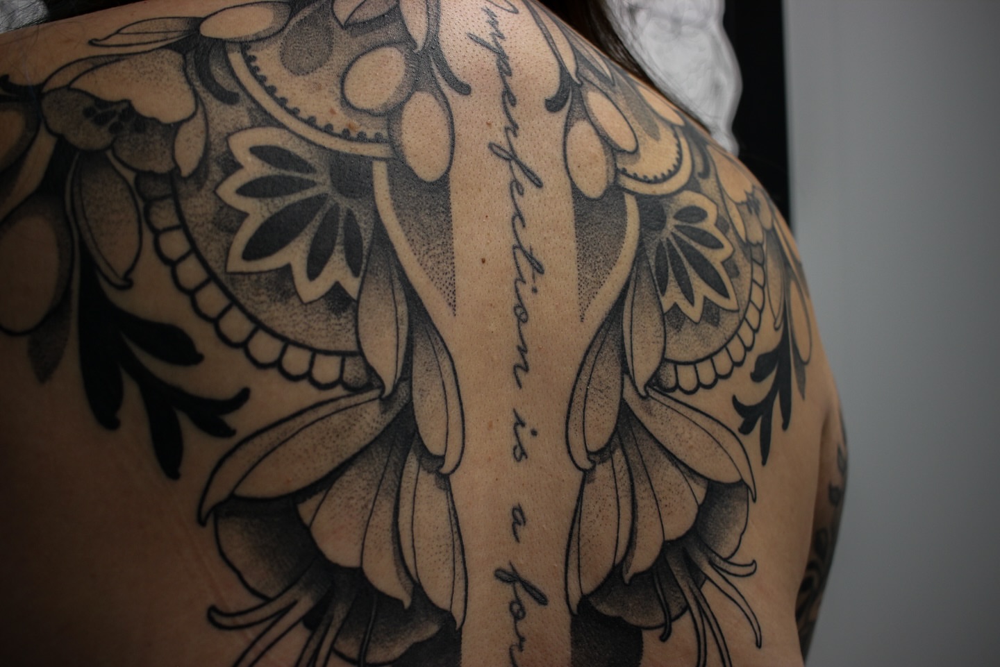 Floral pattern dotwork tattoo on the shoulder by Chris Dobransky