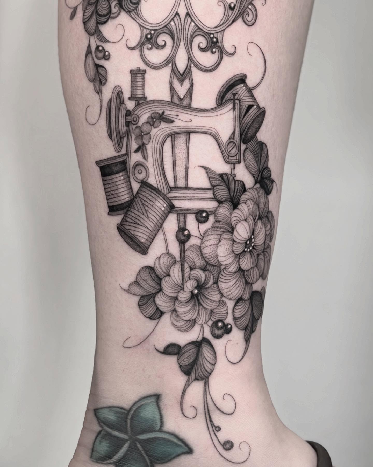 Sewing machine and floral bouquet ornamental tattoo on the forearm by Brittney Naami, San Francisco, California