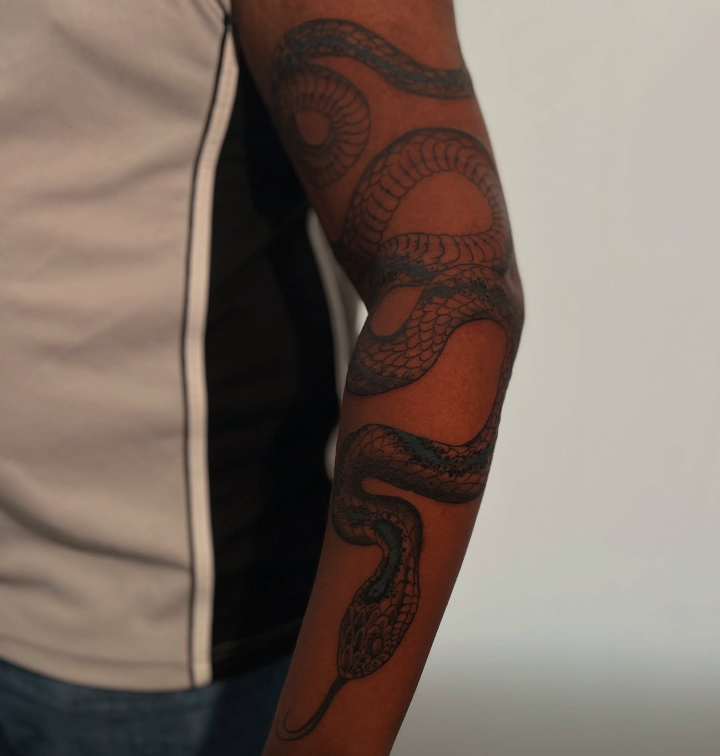 Snake black and grey tattoo on the forearm by H I R A  L U P E - tattoo artist, Oakland, California