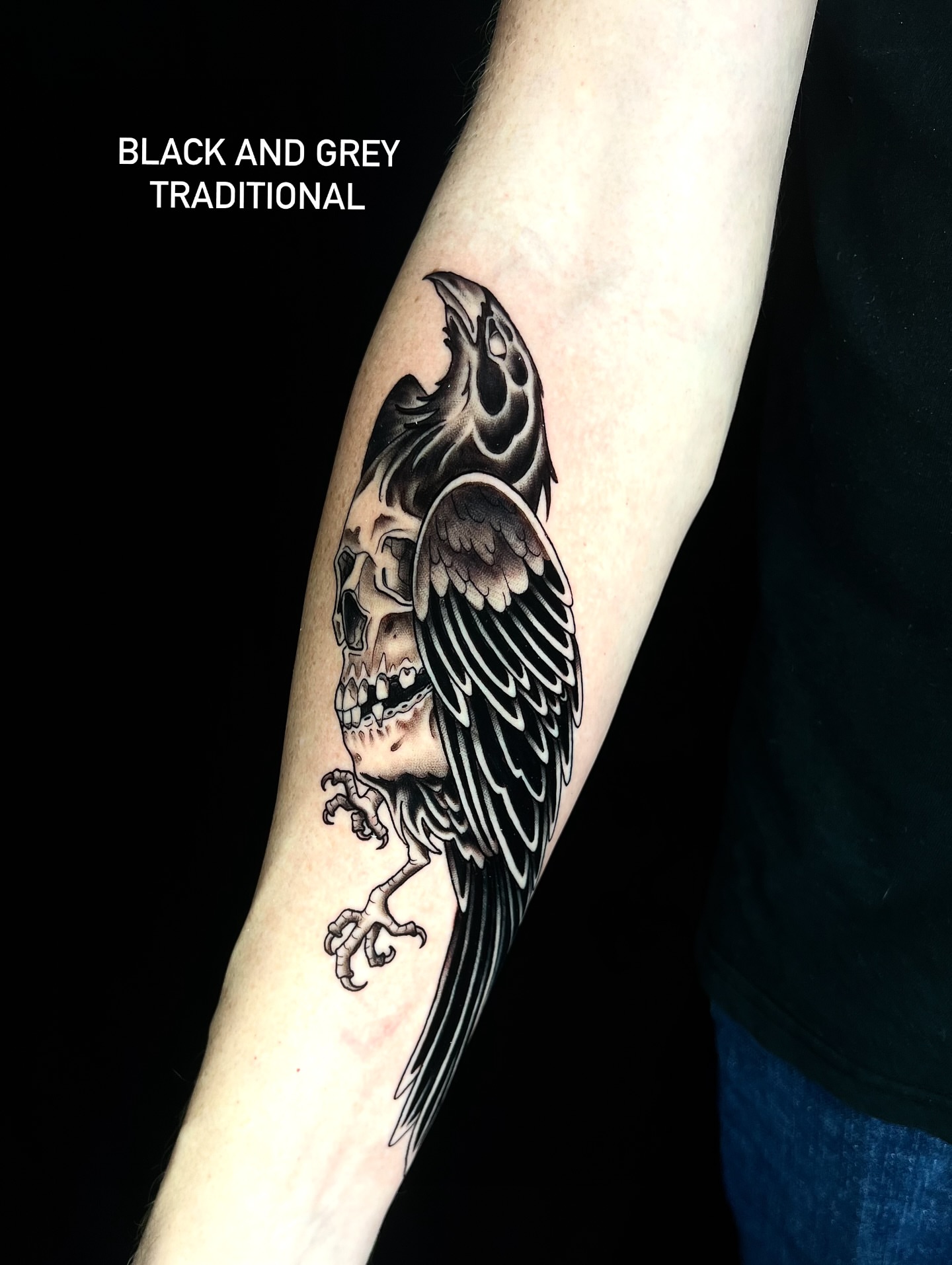 Skull and crow black and grey tattoo on the forearm by Pam Sanders