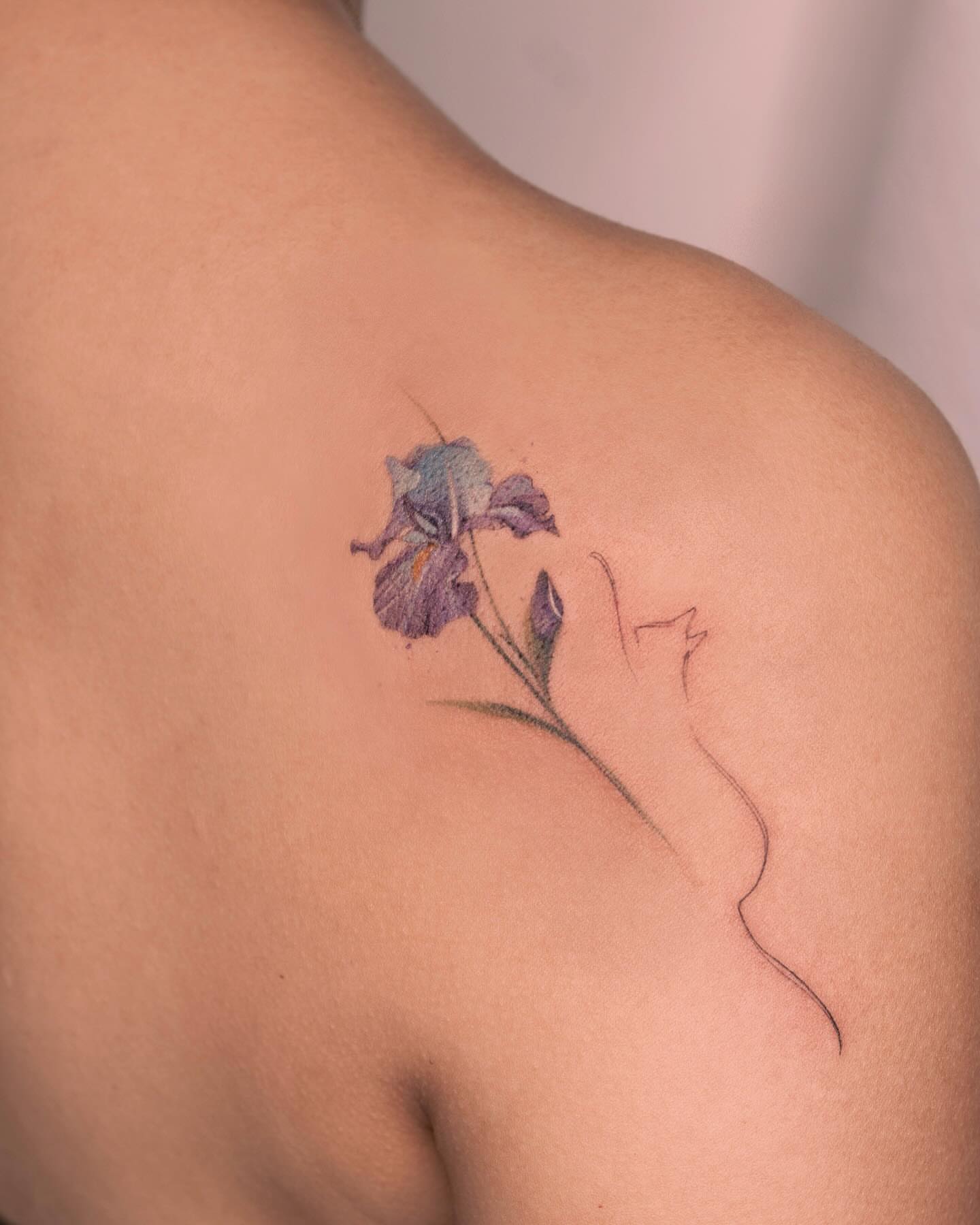 Iris flower realism tattoo on the shoulder by Tattooist hea